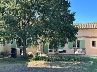 a house with a tree in the yard at 4 bedroom villa, private pool and garden in Cabrières-dʼAvignon