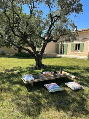 a picnic table in the grass under a tree at 4 bedroom villa, private pool and garden in Cabrières-dʼAvignon