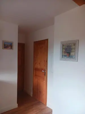 an empty room with a door and a picture on the wall at La poumo d'amour in La Tour-dʼAigues