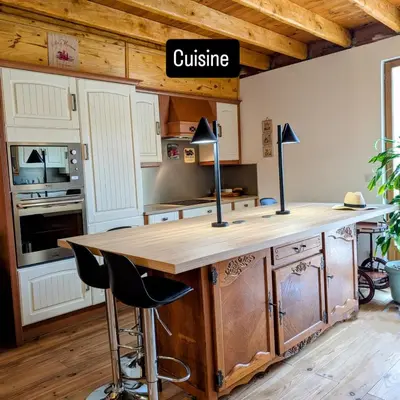 a kitchen with a wooden counter top in a room at La poumo d'amour in La Tour-dʼAigues
