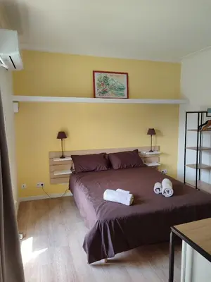 a bedroom with a bed with two towels on it at Chambre indépendante avec SDB privative in Avignon