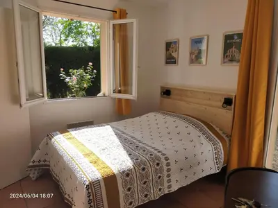 a bedroom with a bed and a window at Studio Les Alizés du Luberon in Pertuis