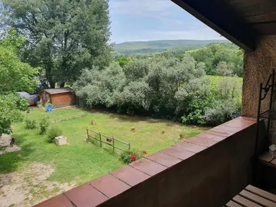 a view of a garden from the balcony of a house at Les Marronniers Charmant petit appartement a La Tour d'Aigues Vaucluse in La Tour-dʼAigues