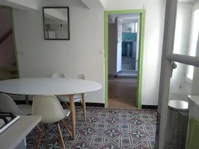 a dining room with a white table and chairs at La Bastide des Jourdans logement entier Duplex in La Bastide-des-Jourdans