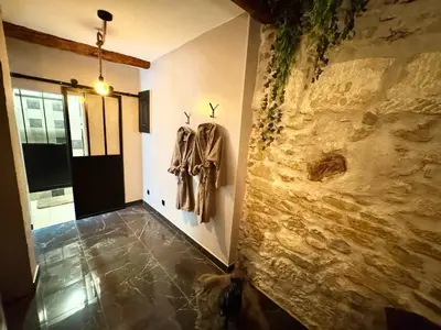 a hallway with coats hanging on a wall at L'Or du Temps - Jacuzzi privé in Lançon-Provence