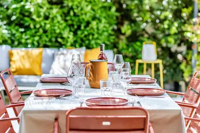 a table with glasses and a bottle of wine on it at Souviens-toit in Puget