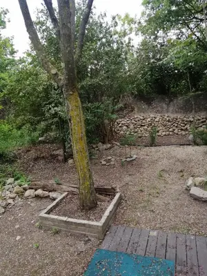 a tree with a yellow sign on the side of it at mobil home chez ANIK & ALAIN in La Roque-dʼAnthéron