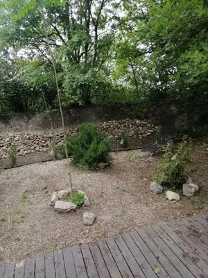a garden with a small tree in the middle at mobil home chez ANIK & ALAIN in La Roque-dʼAnthéron