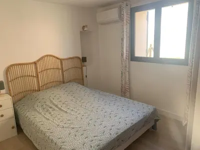 a bedroom with a bed and a window at Maison rénovée 3 chambres in Mollégès