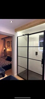 a bedroom with a sliding glass door with a bed at Appartement neuf avec vue in Mallemort