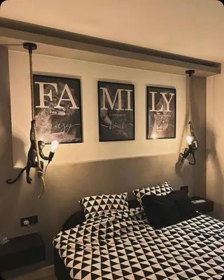 a bedroom with a bed and some pictures on the wall at Appartement neuf avec vue in Mallemort