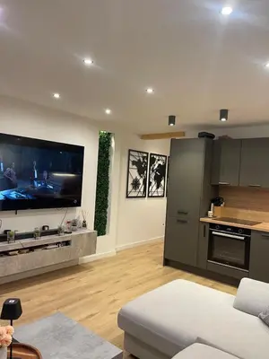 a kitchen with a large flat screen tv on the wall at Appartement neuf avec vue in Mallemort