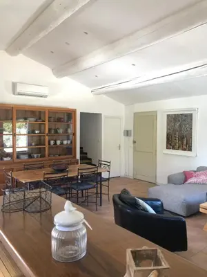 a living room with a couch and a table at Une maison en Provence piscine au pied du Luberon in Mérindol