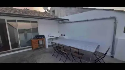 a patio with a table and chairs and a desk at Lubéron Grde Maison de village avec terrasse 4 chambres doubles in Saint-Martin-de-Castillon