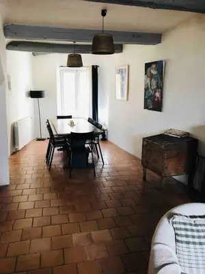 a living room with a table and chairs at Lubéron Grde Maison de village avec terrasse 4 chambres doubles in Saint-Martin-de-Castillon