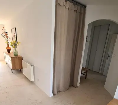 a room with a curtain and a table with a vase on it at 140 m2 villa with pool in Pernes-Les-Fontaines in Pernes-les-Fontaines