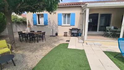 a patio with a table and chairs in front of a house at 140 m2 villa with pool in Pernes-Les-Fontaines in Pernes-les-Fontaines