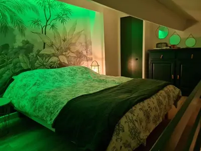a bedroom with a bed with a painting on the wall at Lovely Apartment with a Rooftop View in Aix in Aix-en-Provence