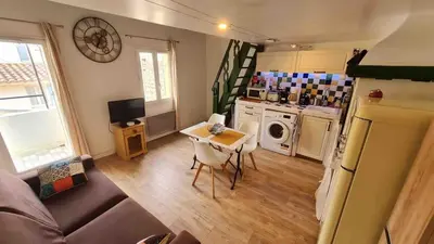 a small living room with a table and a kitchen at Lovely Apartment with a Rooftop View in Aix in Aix-en-Provence