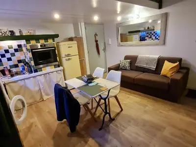 a small living room with a table and a couch at Lovely Apartment with a Rooftop View in Aix in Aix-en-Provence