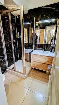 a bathroom with a tub and a sink and a mirror at Lovely Apartment with a Rooftop View in Aix in Aix-en-Provence