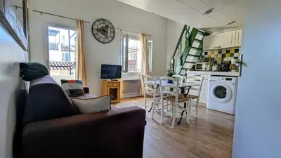 a living room with a couch and a table at Lovely Apartment with a Rooftop View in Aix in Aix-en-Provence