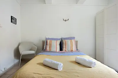 a bedroom with a bed with two pillows on it at Studio Romarin in La Fare-les-Oliviers