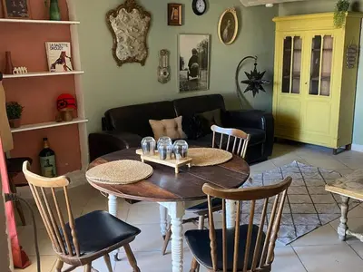 a living room with a table and chairs and a couch at appartement de charme in Lançon-Provence