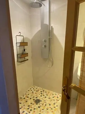 a bathroom with a shower with a glass door at appartement de charme in Lançon-Provence