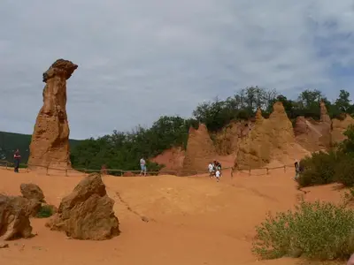 a group of people standing in front of rock formations at Chambres d'Hôtes Chez Cécile à Lagnes in Lagnes