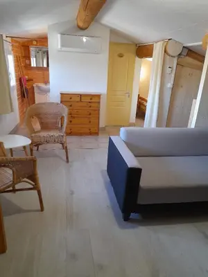 a living room with a couch and a table at Chambres d'Hôtes Chez Cécile à Lagnes in Lagnes