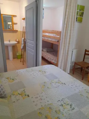 a bedroom with a bed and a bathroom with a bunk bed at Chambres d'Hôtes Chez Cécile à Lagnes in Lagnes