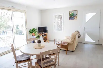 a living room with a table and chairs and a television at La Luberonnette in Saint-Saturnin-les-Apt