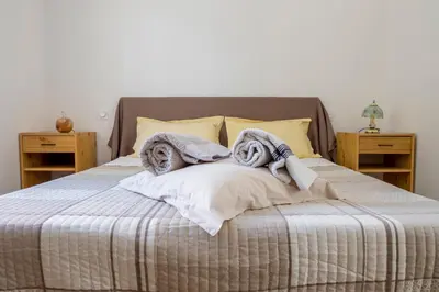 a bedroom with a bed with towels on it at La Luberonnette in Saint-Saturnin-les-Apt