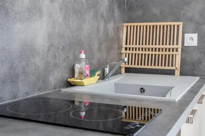a kitchen sink with a bottle of soap and a detergent at La Luberonnette in Saint-Saturnin-les-Apt