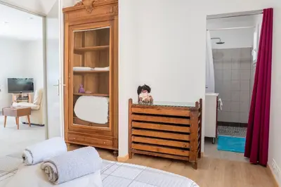 a bedroom with a dog sitting on top of a crib at La Luberonnette in Saint-Saturnin-les-Apt
