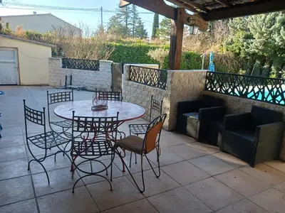 a patio with a table and chairs on a patio at MAISON Terrasse PISCINE in Cavaillon