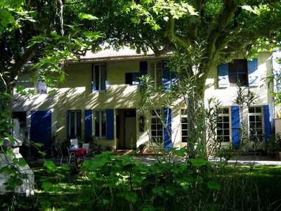 an old house with blue doors and windows at Mas De La Pomme De Pin in Noves
