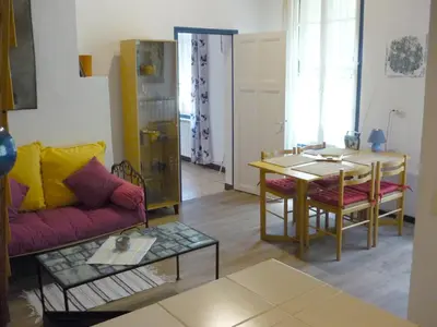 a living room with a couch and a table at Mas De La Pomme De Pin in Noves
