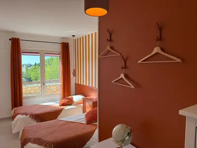 a hotel room with two beds and a window at La maison de Flassan chic et sport in Flassan