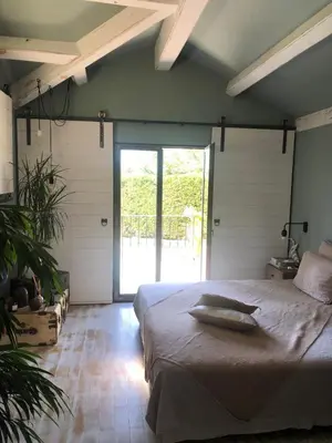 a bedroom with a large bed and a large window at Maison de charme à Aix-en-Provence in Aix-en-Provence