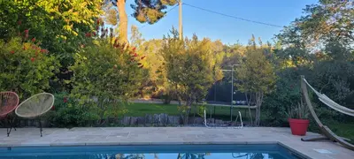 a backyard with a swimming pool and trees at Maison de charme à Aix-en-Provence in Aix-en-Provence