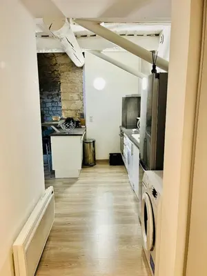 a room with a kitchen and a living room at Charme unique sous les remparts in Châteauneuf-de-Gadagne