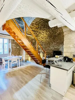 an office with a stone wall and a staircase at Charme unique sous les remparts in Châteauneuf-de-Gadagne