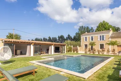 a backyard with a swimming pool and a house at Le Champ des Cigales in Noves