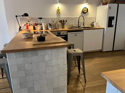 a kitchen with a counter and a refrigerator at Maison de village en Provence Luberon in Saint-Saturnin-les-Apt