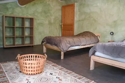 a bedroom with two beds and a rug at Maison provençale avec piscine et vue in Viens