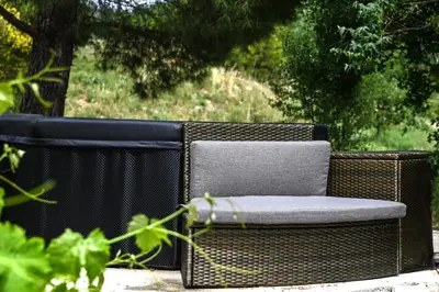 a wicker chair sitting on the ground in a yard at Maison provençale avec piscine et vue in Viens