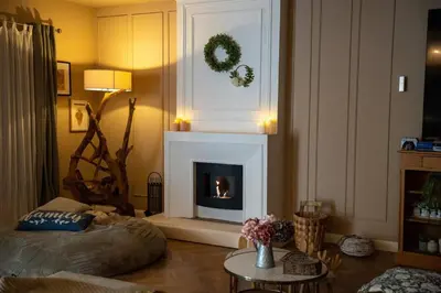 a living room with a fireplace and a table at La Maison PP une Parenthèse Provençale in Carpentras