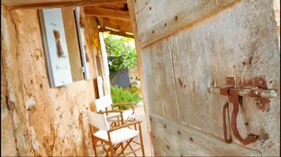 a room with a wooden wall with chairs and a table at Hameau de l'Esperelle in Simiane-la-Rotonde